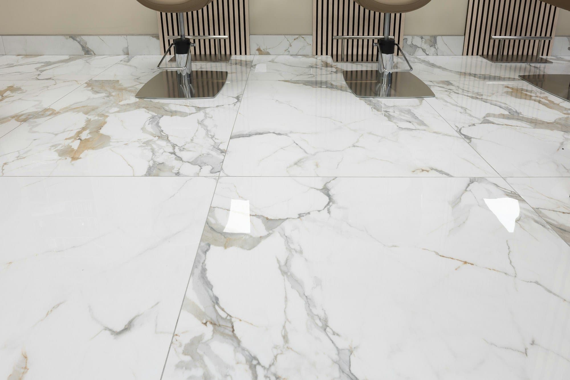 Large-format marble-look floor tile with tight grout lines