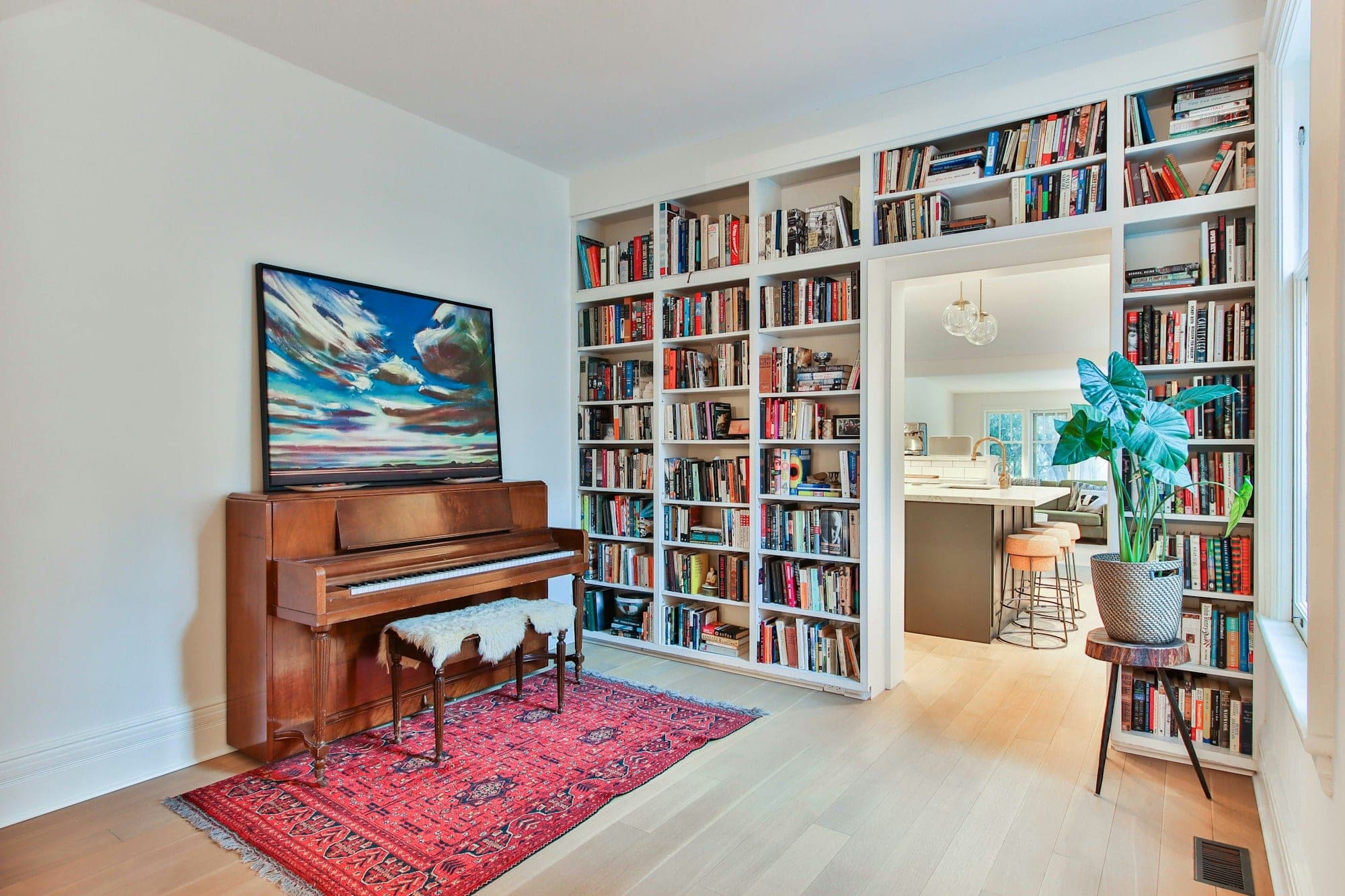 Floor-to-ceiling built-in bookshelves framing a doorway in a bright living room